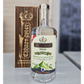Bottle of Chhaanster Raksi with wooden box on a neutral background